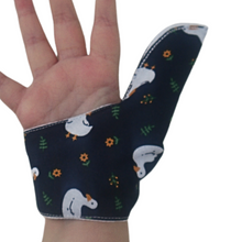 Load image into Gallery viewer, Close up image of a White ducks on a dark background-themed thumb guard to help stop thumb sucking and other habits. Has a moisture resistant lining. The Thumb Guard Store.
