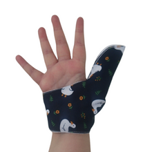 Load image into Gallery viewer, Palm side of a White ducks on a dark background-themed thumb guard to help stop thumb sucking and other habits. Has a moisture resistant lining. The Thumb Guard Store.
