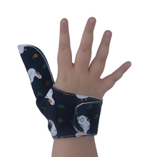 Load image into Gallery viewer, White ducks on a dark background-themed thumb guard to help stop thumb sucking and other habits. Has a moisture resistant lining. The Thumb Guard Store.
