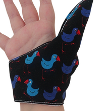 Load image into Gallery viewer, A fabric thumb guard to help break habits such as thumb sucking, nail biting and skin picking, in a Pukeko-themed fabric. The image shows the fabric detail. The guard has a moisture-resistant lining.   Made by the Thumb Guard Store.
