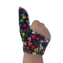 Load image into Gallery viewer, Image shows thumb portion  of a Hearts on a dark background-themed thumb guard to help stop thumb sucking and other habits. Has a moisture resistant lining. The Thumb Guard Store.
