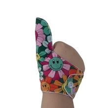 Load image into Gallery viewer, A fabric thumb guard made by The Thumb Guard Store, designed to help children and adults stop habits such as thumb sucking and skin picking. The guard in the image has a smiling flower-themed outer fabric and hand in thumbs up position
