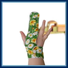 Load image into Gallery viewer, Fabric finger guard to help stop finger sucking habits. The fabric design features daisies on a grass green background. This fabric has a glitter effect . Made by The Thumb Guard Store
