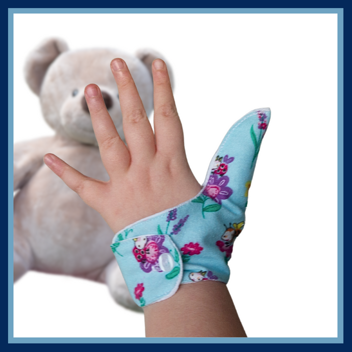 blue coloured thumb guard with a bugs and bees floral design. Moisture resistant lining, to help stop thumb sucking. Made by The Thumb Guard Store