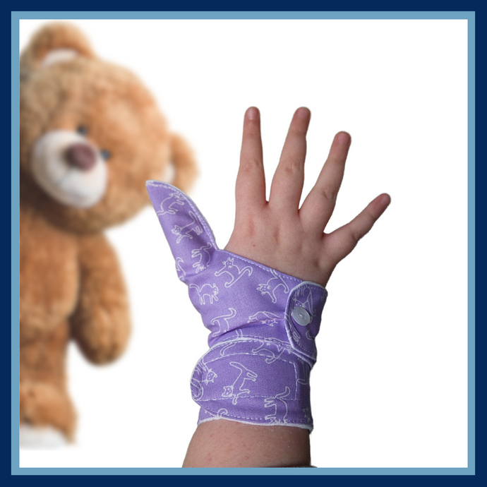 Purple coloured cuffed thumb guard with a cat design. Moisture resistant lining, to help stop thumb sucking. Made by The Thumb Guard Store.