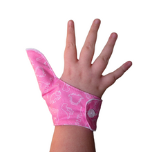 Load image into Gallery viewer, Pink coloured thumb guard with a dinosaur design. Moisture resistant lining, to help stop thumb sucking. Made by The Thumb Guard Store.
