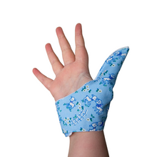 Load image into Gallery viewer, Blue  coloured thumb guard with a lamb design. Moisture resistant lining, to help stop thumb sucking. Made by The Thumb Guard Store.
