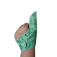 Load image into Gallery viewer, green coloured thumb guard with a lamb design. Moisture resistant lining, to help stop thumb sucking. Made by The Thumb Guard Store
