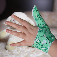 Load image into Gallery viewer, green coloured thumb guard with a lamb design. Moisture resistant lining, to help stop thumb sucking. Made by The Thumb Guard Store
