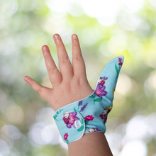 Load image into Gallery viewer, blue coloured thumb guard with a bugs and bees floral design. Moisture resistant lining, to help stop thumb sucking. Made by The Thumb Guard Store
