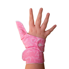 Load image into Gallery viewer, Pink coloured cuffed thumb guard with a dinosaur design. Moisture resistant lining, to help stop thumb sucking. Made by The Thumb Guard Store.
