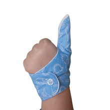 Load image into Gallery viewer, Blue coloured thumb guard with a dinosaur design. Moisture resistant lining, to help stop thumb sucking. Made by The Thumb Guard Store.
