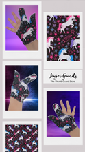 Load image into Gallery viewer, Unicorn-themed glittery fabric on a black background. Thumb Guard with moisture-resistant lining and various fastening options available. Made by The Thumb Guard Store to help stop finger-sucking and other habits. 
