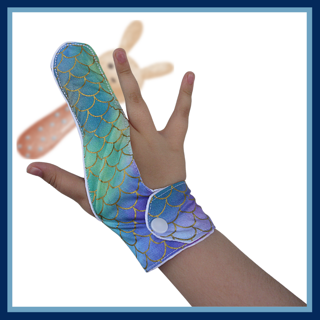A finger guard to help children stop finger-sucking and other habits. Guard has a moisture-resistant lining. The outer fabric features a glittery blue, purple and green mermaid tail design.  A choice of fastenings is available. The Thumb Guard Store