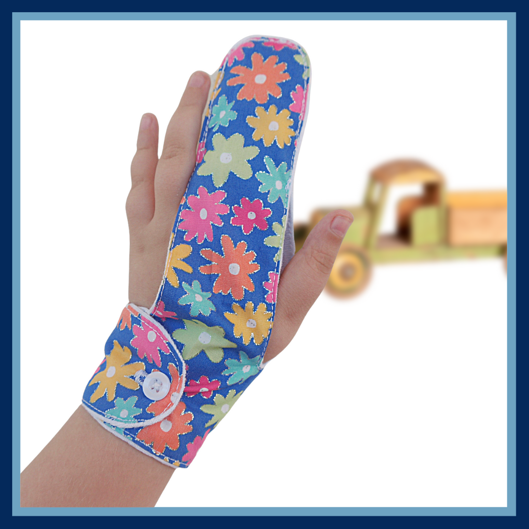 A finger guard to help stop finger sucking habits. Fabric background is blue and features colourful flowers. Has a moisture resistant lining . Made by the Thumb Guard Store