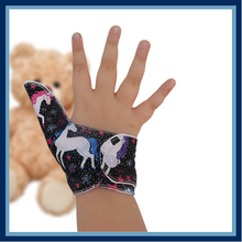 Load image into Gallery viewer, Unicorn-themed glittery fabric on a black background. Thumb Guard with moisture-resistant lining and various fastening options available. Made by The Thumb Guard Store to help stop finger-sucking and other habits.
