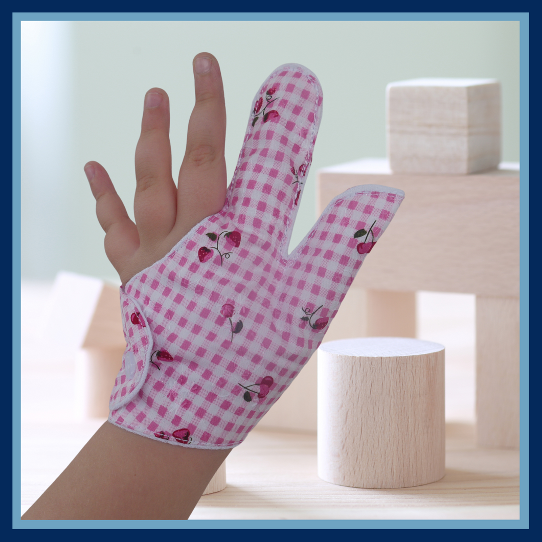 Prevent thumb sucking with this pink check, fruit themed, fabric thumb and finger guard. Features strawberry and cherry design, moisture-resistant lining, and various fastening options. Say goodbye to the habit with comfort and style.