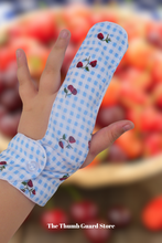 Load image into Gallery viewer, Finger guard glove to help children and adults stop finger sucking. Blue Gingham strawberry and cherry theme theme
